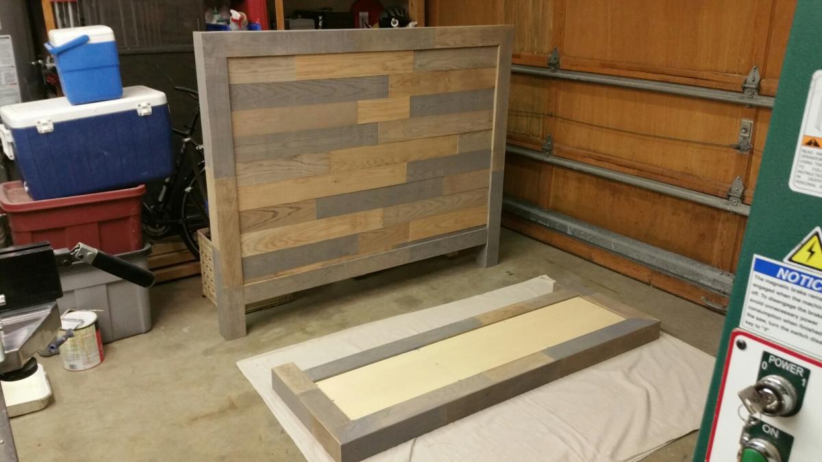 Headboard panel with veneers applied and footboard being prepped for application of the veneers