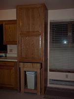 This is an Oak cabinet with a pantry cabinet  top section and a butcher block storage area in the bottom section.  The cabinet is stained with cherry stain and satin wipe on poly.

The pantry features the bottom two shelves on drawer slides.  The top three shelves are on shelf standards.  The door has 5 spice shelves with galley rail.  The door is mounted on 4 hinges that open 165 degrees to allow the shelves to clear the door.