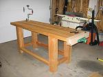 This is a French Style workbench I built from the example in Christopher Schwarz's Workbenches book. 

The base is made from douglas fir from my local home center. The top is hickory and it's really hard!

The finish is a coat of boiled linseed oil with just a bit of varnish.
