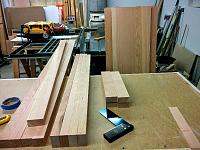 Fir panels (right side, leaning agains the table saw) are glued up and rough sized, and the cherry frame pieces are cut to size awaiting layout of...
